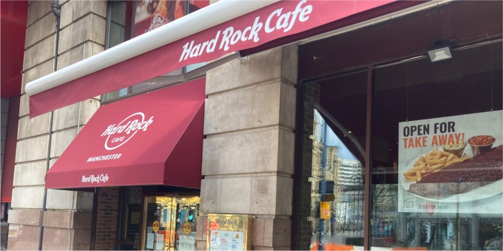 Hard Rock Cafe in Manchester City Centre, UK. Rock and Roll themed chain restaurant in the North of England. Canopy & Awnings supplied with white printing to covers and valances by Parker Masters Ltd.
