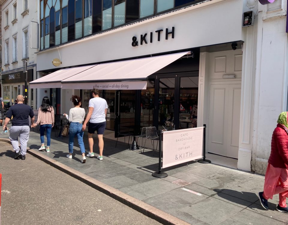 & Kith Cafe Bakehouse in Leicester City Centre. American inspired cafe and dry bar in the middle of Leicestershire. Retractable awning valance and cafe barrier banner printed in Pantone colour by Parker Masters Ltd.