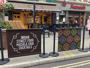 Papa Dum Restaurant in London City Centre. Indian street food cuisine in the capital of England. Bespoke branding for the awning, valance and cafe barrier banners all over printing in full colour by Parker Masters Ltd.
